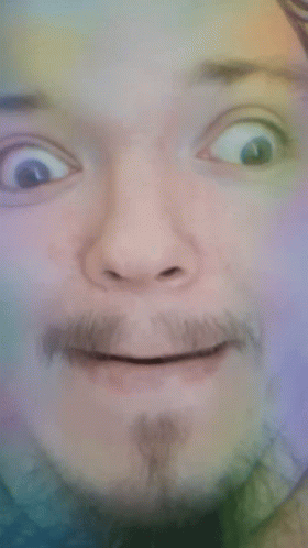 A Close Up Of A Man 'S Face With A Beard Making A Funny Face GIF