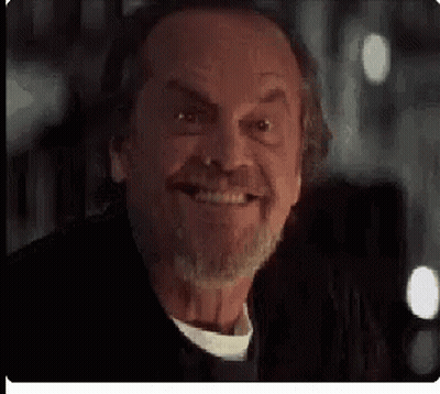 A Close Up Of A Man 'S Face With A Beard Smiling . GIF