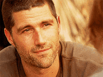 A Close Up Of A Man 'S Face With A Beard Smiling GIF
