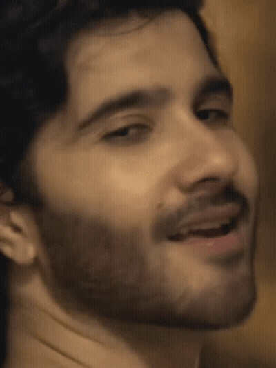 A Close Up Of A Man 'S Face With A Beard Smiling GIF