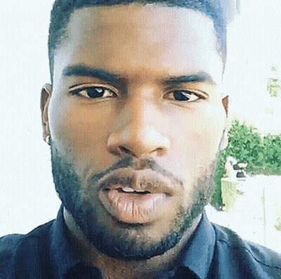 A Close Up Of A Man 'S Face With A Beard Wearing A Black Shirt GIF