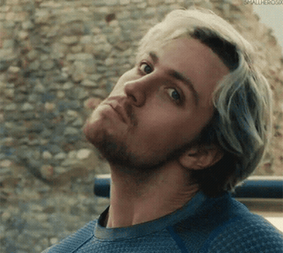 A Close Up Of A Man 'S Face With A Beard Wearing A Blue Sweater . GIF