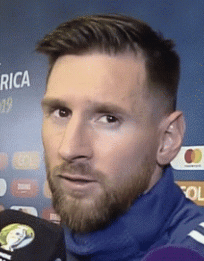 A Close Up Of A Man 'S Face With A Beard Wearing A Blue Sweater . GIF