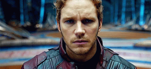 A Close Up Of A Man 'S Face With A Beard Wearing A Leather Jacket . GIF