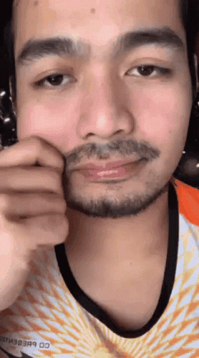 A Close Up Of A Man 'S Face With A Beard Wearing A Nike Shirt GIF