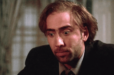 A Close Up Of A Man 'S Face With A Beard Wearing A Suit And Tie GIF