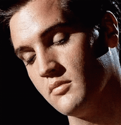 A Close Up Of A Man 'S Face With A Black Background GIF
