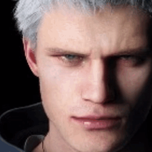 A Close Up Of A Man 'S Face With A Black Background And A Shadow On His Face . GIF
