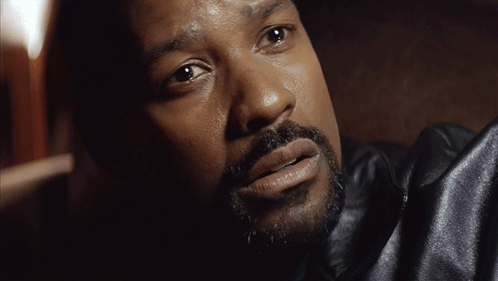 A Close Up Of A Man 'S Face With A Black Jacket On GIF