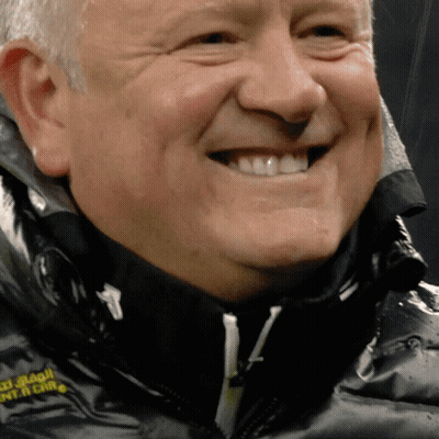 A Close Up Of A Man 'S Face With A Black Jacket That Says ' South China ' On The Front GIF