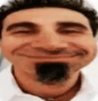 A Close Up Of A Man 'S Face With A Black Mustache Smiling . GIF