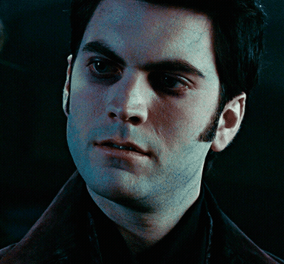 A Close Up Of A Man 'S Face With A Black Shirt On GIF