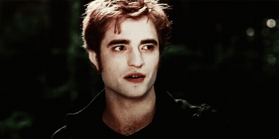 A Close Up Of A Man 'S Face With A Black Shirt On And A Dark Background . GIF