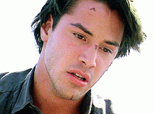A Close Up Of A Man 'S Face With A Black Shirt On . GIF