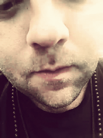 A Close Up Of A Man 'S Face With A Black Shirt On GIF