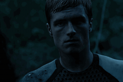 A Close Up Of A Man 'S Face With A Blue Background GIF