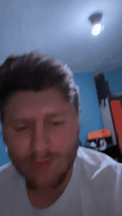 A Close Up Of A Man 'S Face With A Blue Background GIF