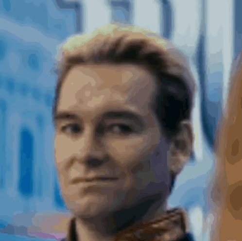 A Close Up Of A Man 'S Face With A Blue Background And A Blurred Background . GIF