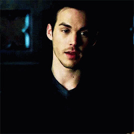 A Close Up Of A Man 'S Face With A Blue Background GIF