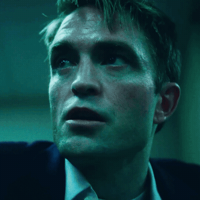 A Close Up Of A Man 'S Face With A Blue Background GIF