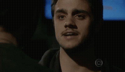 A Close Up Of A Man 'S Face With A Blue Background . GIF