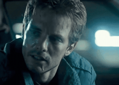 A Close Up Of A Man 'S Face With A Blue Background GIF