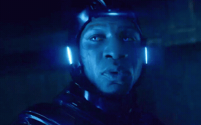 A Close Up Of A Man 'S Face With A Blue Light Behind Him GIF