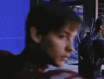 A Close Up Of A Man 'S Face With A Blue Screen Behind Him GIF