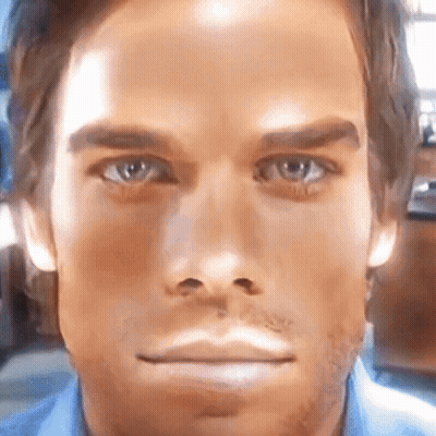 A Close Up Of A Man 'S Face With A Blue Shirt GIF
