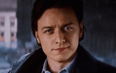 A Close Up Of A Man 'S Face With A Blue Shirt And A Blue Jacket . GIF