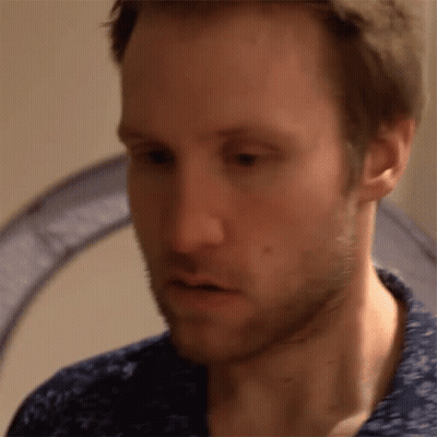 A Close Up Of A Man 'S Face With A Blue Shirt GIF