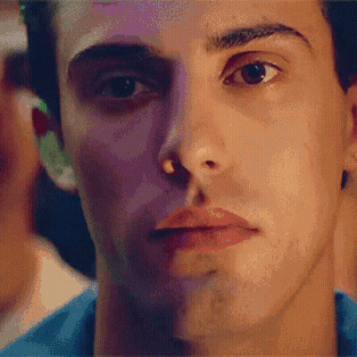A Close Up Of A Man 'S Face With A Blue Shirt GIF