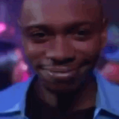 A Close Up Of A Man 'S Face With A Blue Shirt On GIF