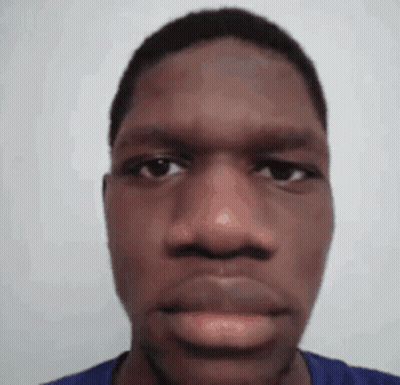 A Close Up Of A Man 'S Face With A Blue Shirt On Against A White Background . GIF