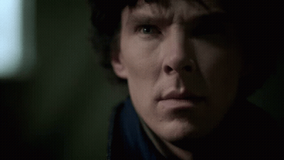 A Close Up Of A Man 'S Face With A Blue Shirt On GIF