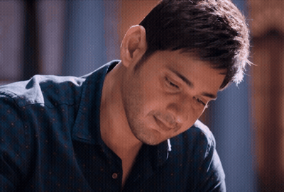 A Close Up Of A Man 'S Face With A Blue Shirt On GIF