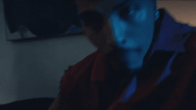A Close Up Of A Man 'S Face With A Blue Shirt That Says ' A ' On It GIF