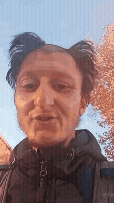 A Close Up Of A Man 'S Face With A Blue Sky In The Background . GIF