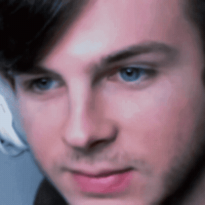 A Close Up Of A Man 'S Face With A Blurred Background GIF