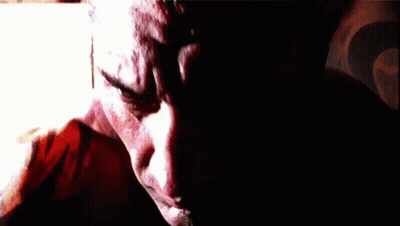A Close Up Of A Man 'S Face With A Blurred Background GIF