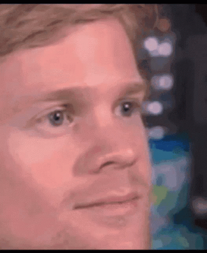 A Close Up Of A Man 'S Face With A Blurred Background . GIF