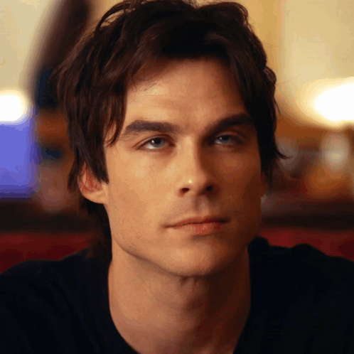 A Close Up Of A Man 'S Face With A Blurred Background GIF