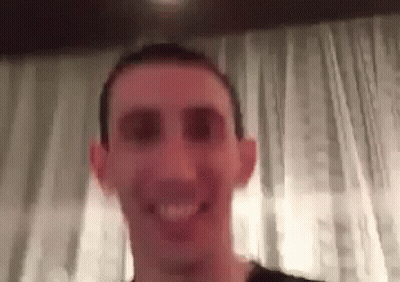 A Close Up Of A Man 'S Face With A Blurred Background . GIF