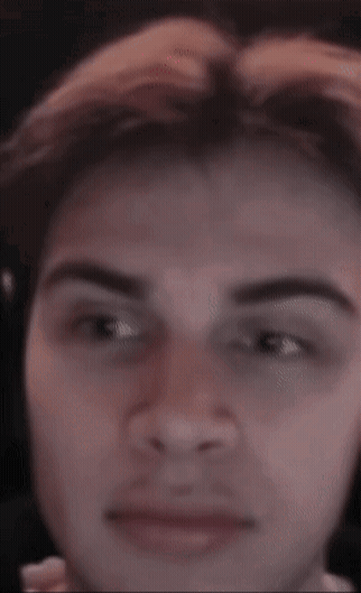 A Close Up Of A Man 'S Face With A Blurred Background GIF