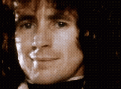 A Close Up Of A Man 'S Face With A Blurred Background GIF