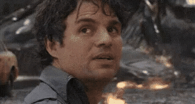A Close Up Of A Man 'S Face With A Blurred Background Looking At The Camera . GIF
