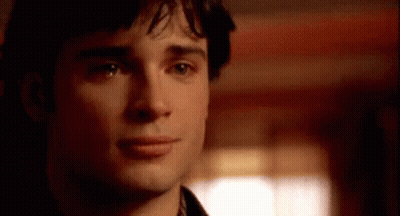 A Close Up Of A Man 'S Face With A Blurred Background Looking At The Camera . GIF