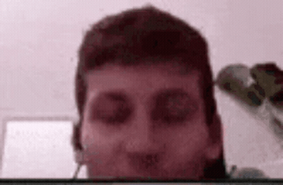 A Close Up Of A Man 'S Face With A Blurred Background . GIF