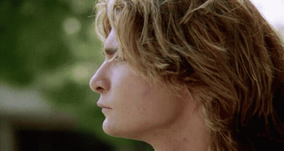 A Close Up Of A Man 'S Face With A Blurred Background GIF