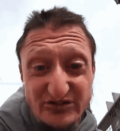A Close Up Of A Man 'S Face With A Blurred Background That Says ' Larsonrecorder ' On It GIF